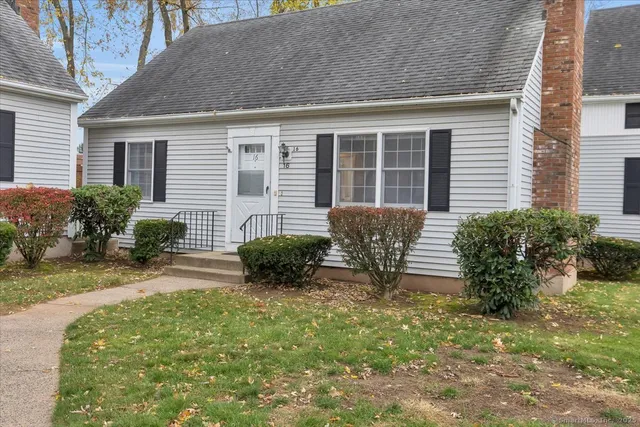 a view of a house with a yard and plants