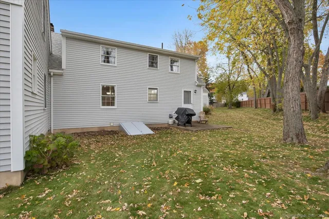 a backyard of a house with table and chairs