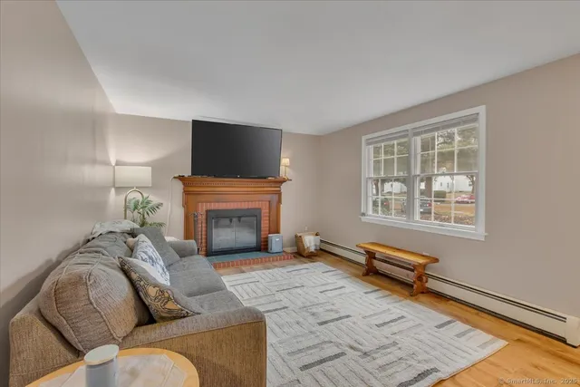 a living room with furniture a fireplace and a flat screen tv