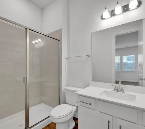 a bathroom with a sink toilet and shower