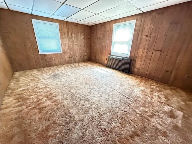 a view of a room with a window and a ceiling fan