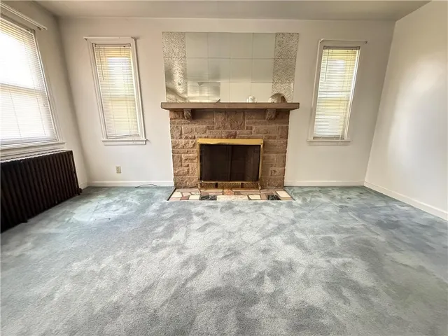a view of empty room with a fireplace
