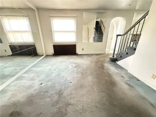 a kitchen with a sink a refrigerator and cabinets