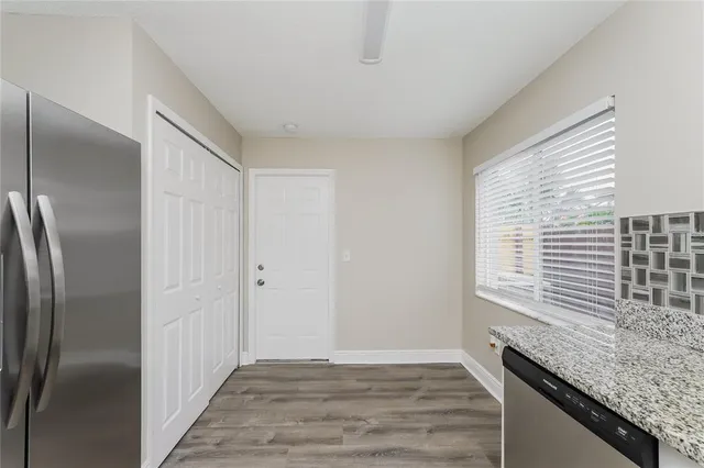 a kitchen with stainless steel appliances granite countertop a refrigerator and a sink