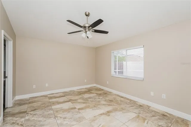 a view of a livingroom with a ceiling fan and window