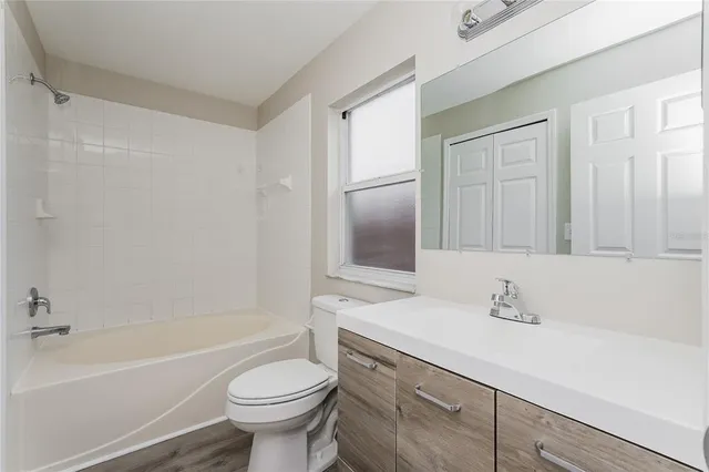 a bathroom with a sink a toilet and a bathtub