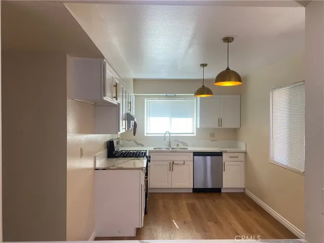 a kitchen with a sink cabinets and window