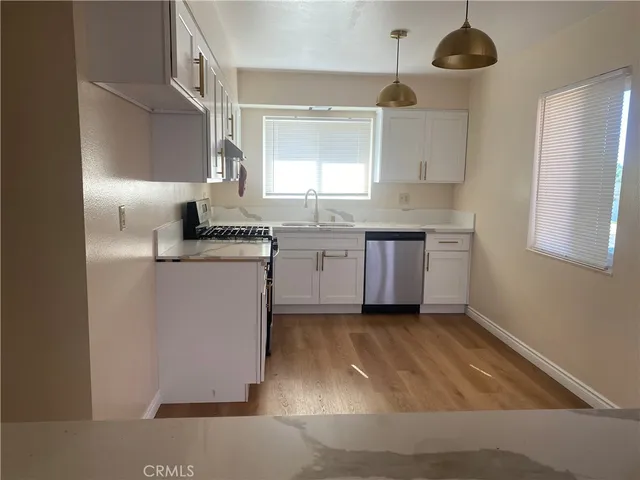 a kitchen with a sink cabinets and window