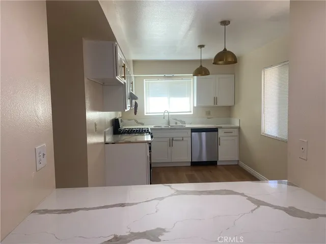 a kitchen with a stove a sink and a refrigerator