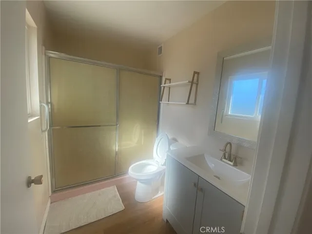 a white toilet sitting next to a bath tub