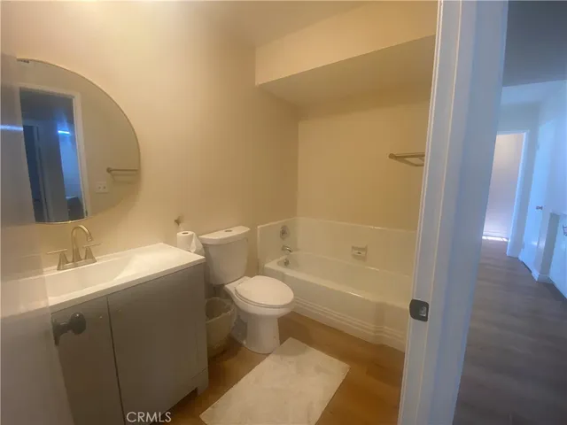 a white toilet sitting next to a bathroom sink
