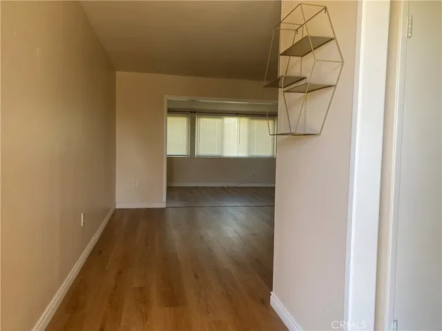 a view of hallway with wooden floor