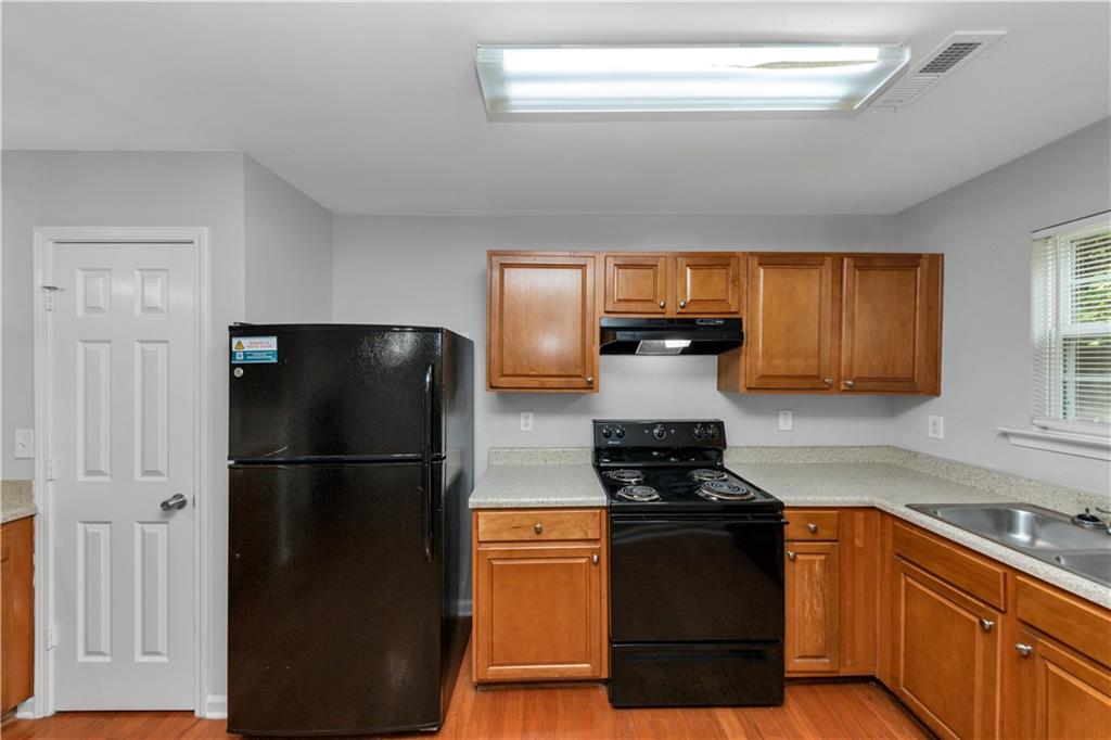 735 Crestwell Circle Atlanta, GA 30331 - Photo 11 of 31 a kitchen with a refrigerator stove and cabinets