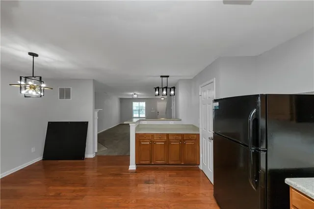 a kitchen with a refrigerator and a sink