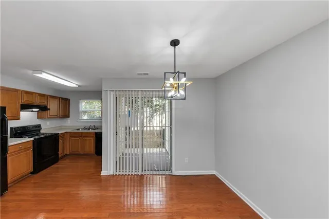 a view of a kitchen with granite countertop stainless steel appliances and wooden floor