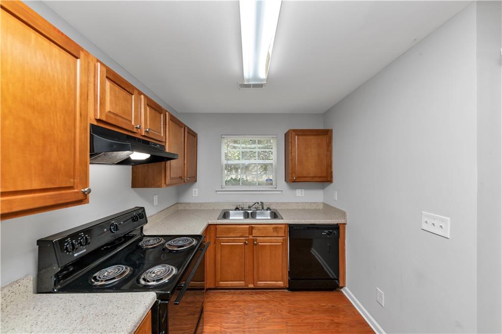 735 Crestwell Circle Atlanta, GA 30331 - Photo 9 of 31 a kitchen with a stove and a refrigerator