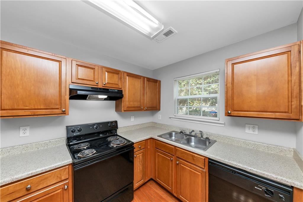 735 Crestwell Circle Atlanta, GA 30331 - Photo 10 of 31 a kitchen with stainless steel appliances granite countertop a sink stove and cabinets