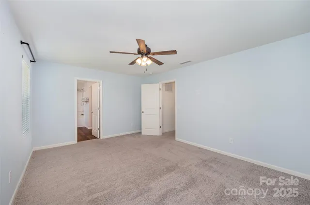 a view of a livingroom with a ceiling fan and a chandelier fan