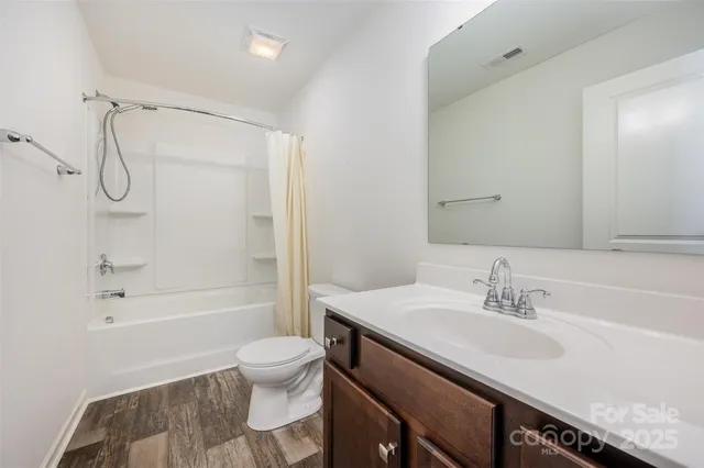 a bathroom with a sink granite toilet tub and shower
