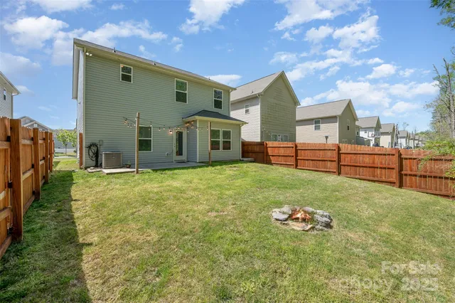 a view of a house with backyard and sitting area