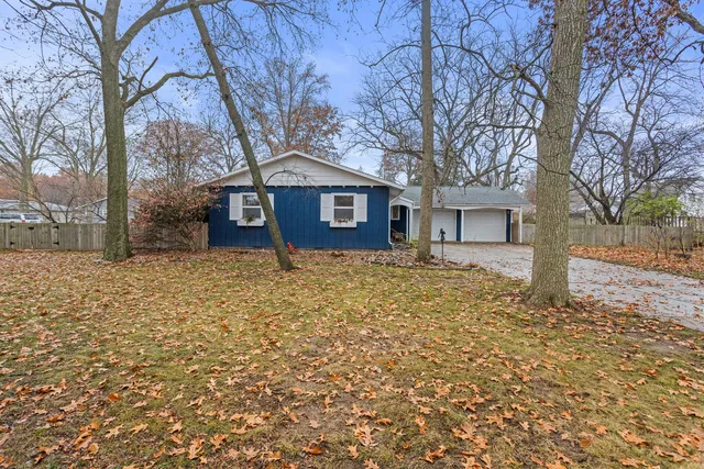 a view of a house with a yard covered with snow