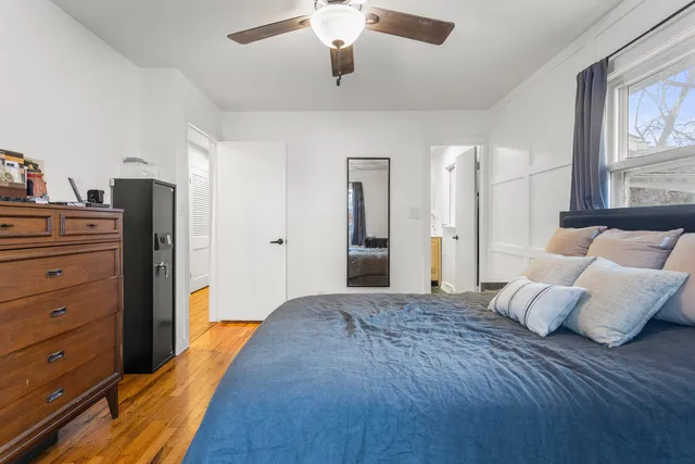 a bedroom with a bed and wooden floor