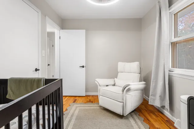 a living room with furniture and a air conditioner vent