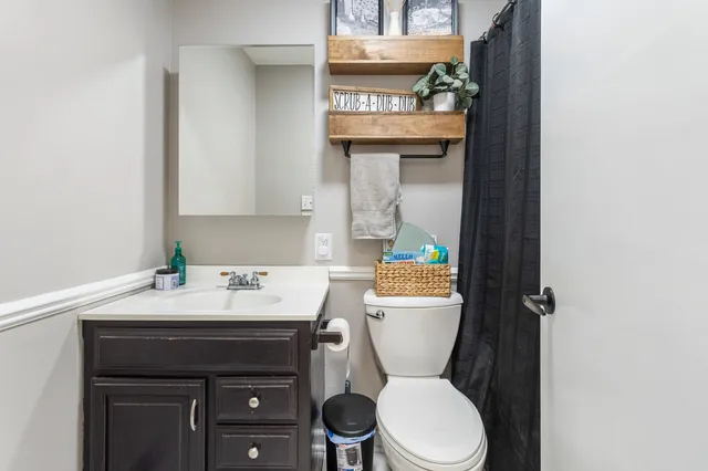a bathroom with a sink toilet and mirror
