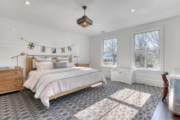 a spacious bedroom with a large bed and a window