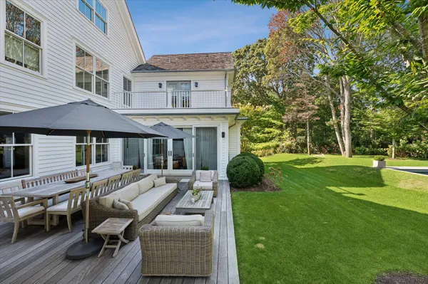 a view of a house with a yard and sitting area