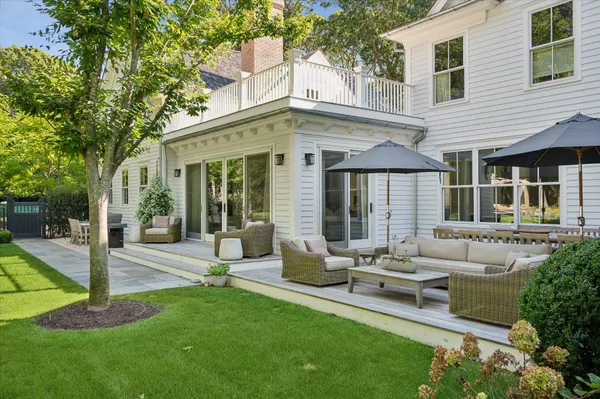 a view of a house with backyard sitting area and garden