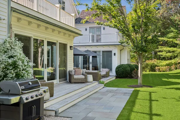 a view of a house with backyard porch and sitting area