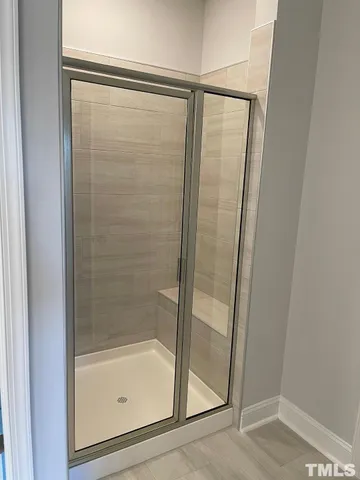 a bathroom with a glass shower door