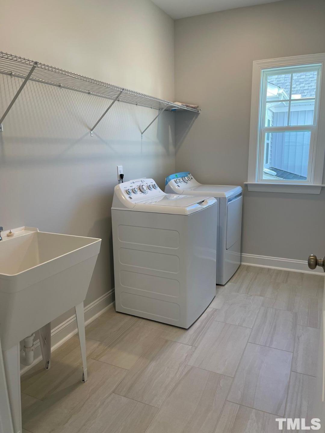 168 Edge Of Auburn Boulevard Raleigh, NC 27610 - Photo 19 of 19 a utility room with a washer and dryer