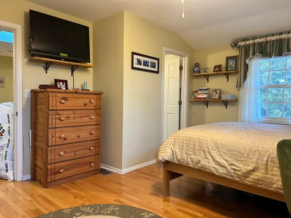 a bedroom with a bed and flat screen tv