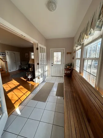 a spacious bathroom with a large mirror and a ceiling fan