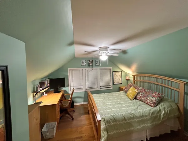 a bedroom with furniture and wooden floor