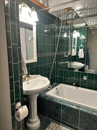 a bedroom with a bed and a workspace