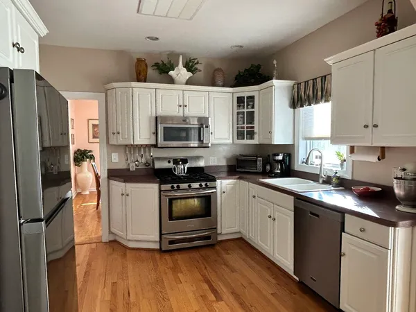a kitchen with cabinets stainless steel appliances a sink and a counter top space