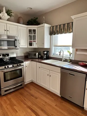 a kitchen with a sink stove and microwave