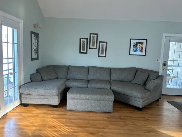 a living room with couches and a night stand
