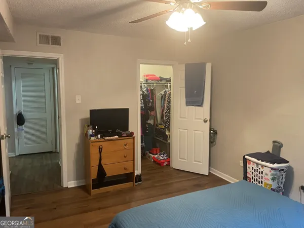 a bedroom with a bed and a window with painted walls