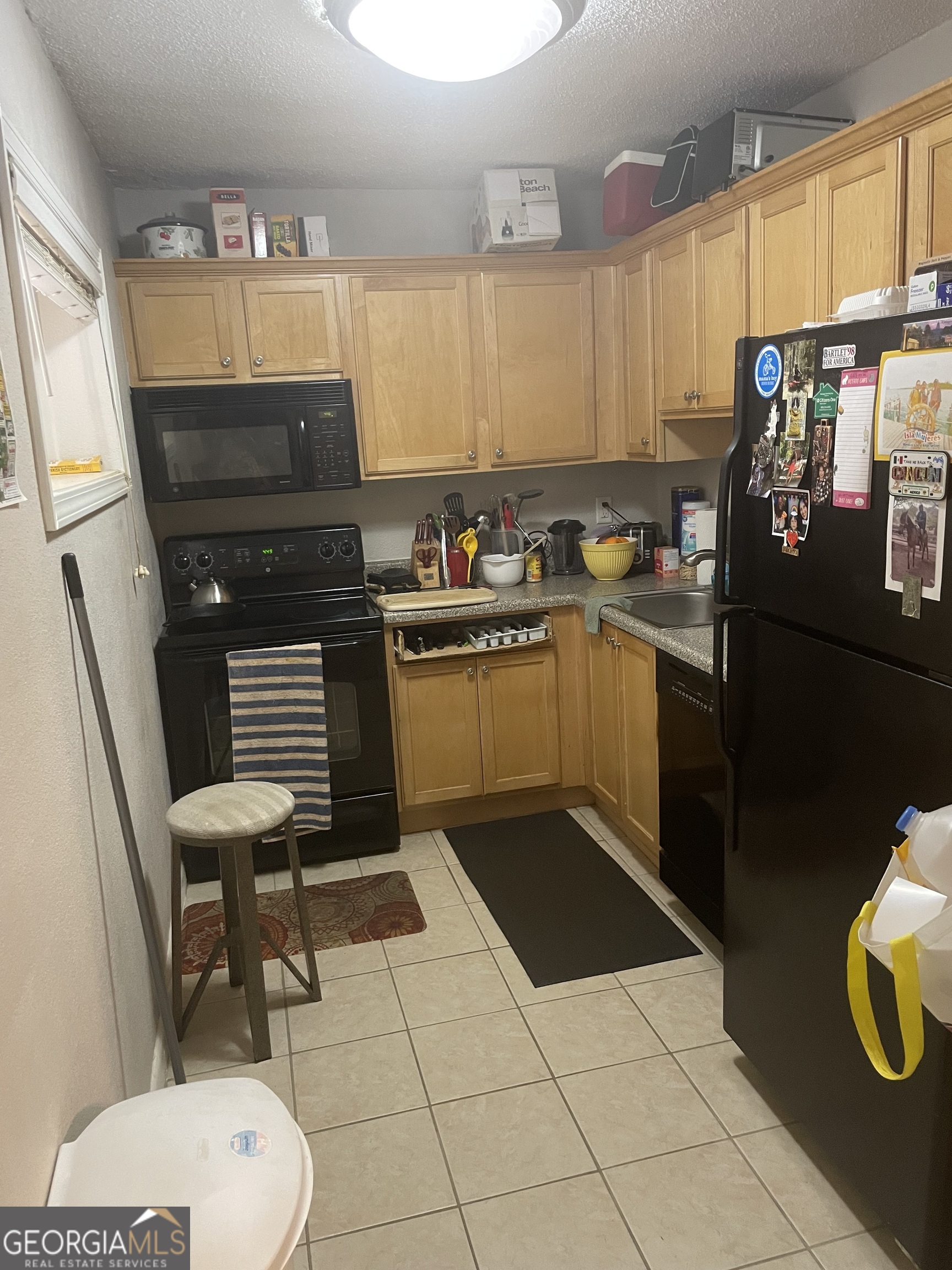 250 Little Street, Unit B102 Athens, GA 30605 - Photo 3 of 20 a kitchen with a refrigerator and a stove top oven