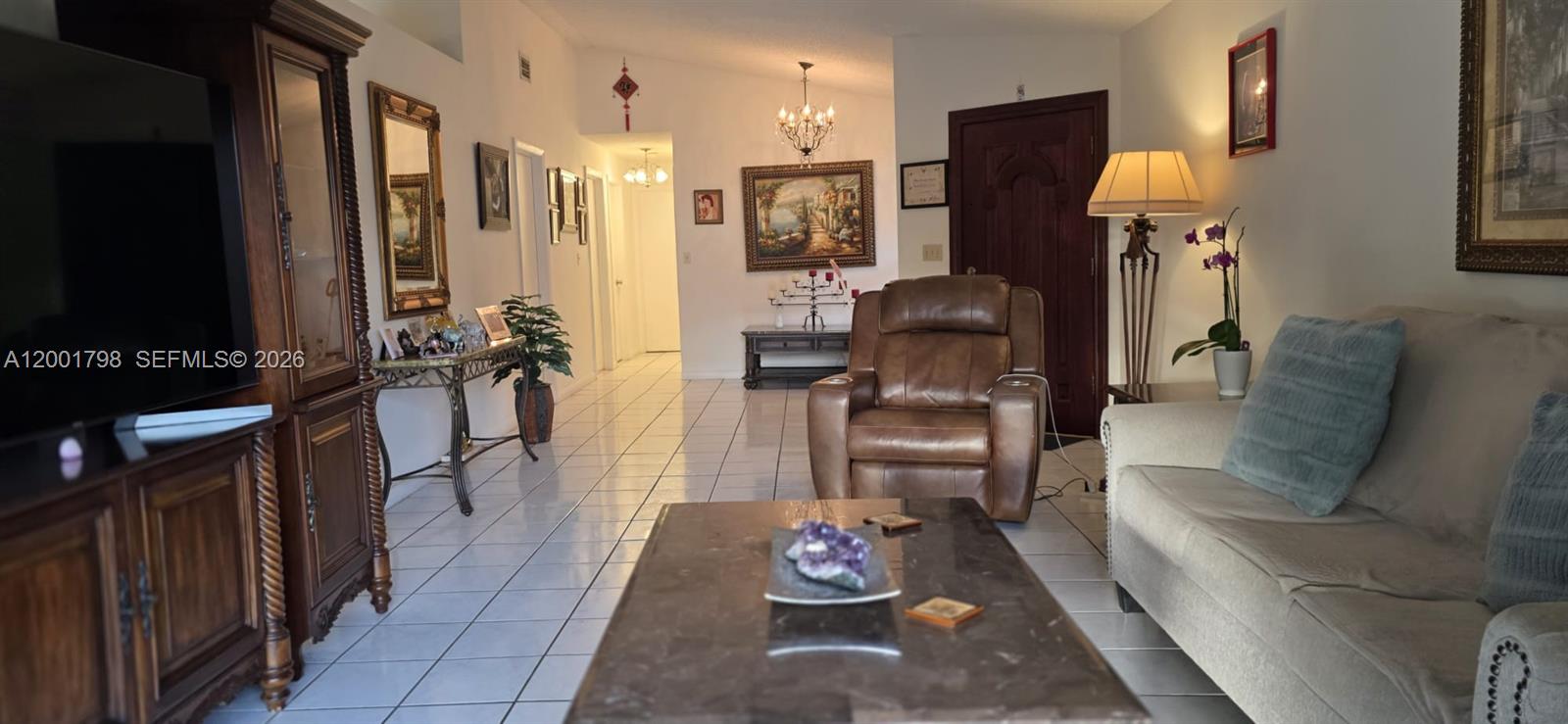 14971 Southwest 75th Terrace Miami, FL 33193 - Photo 12 of 24 a living room with furniture and a flat screen tv