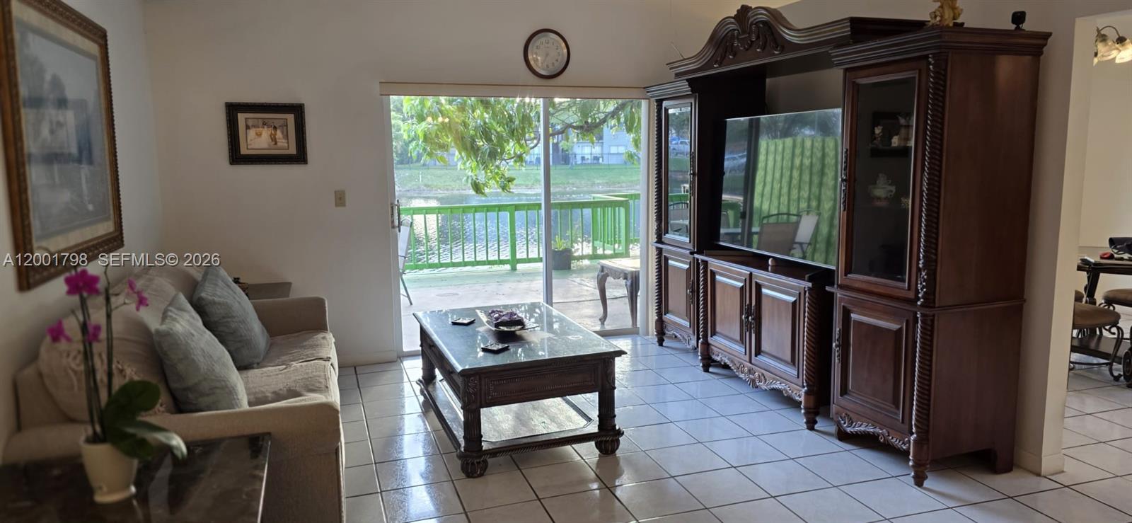 14971 Southwest 75th Terrace Miami, FL 33193 - Photo 13 of 24 a living room with furniture and a flat screen tv