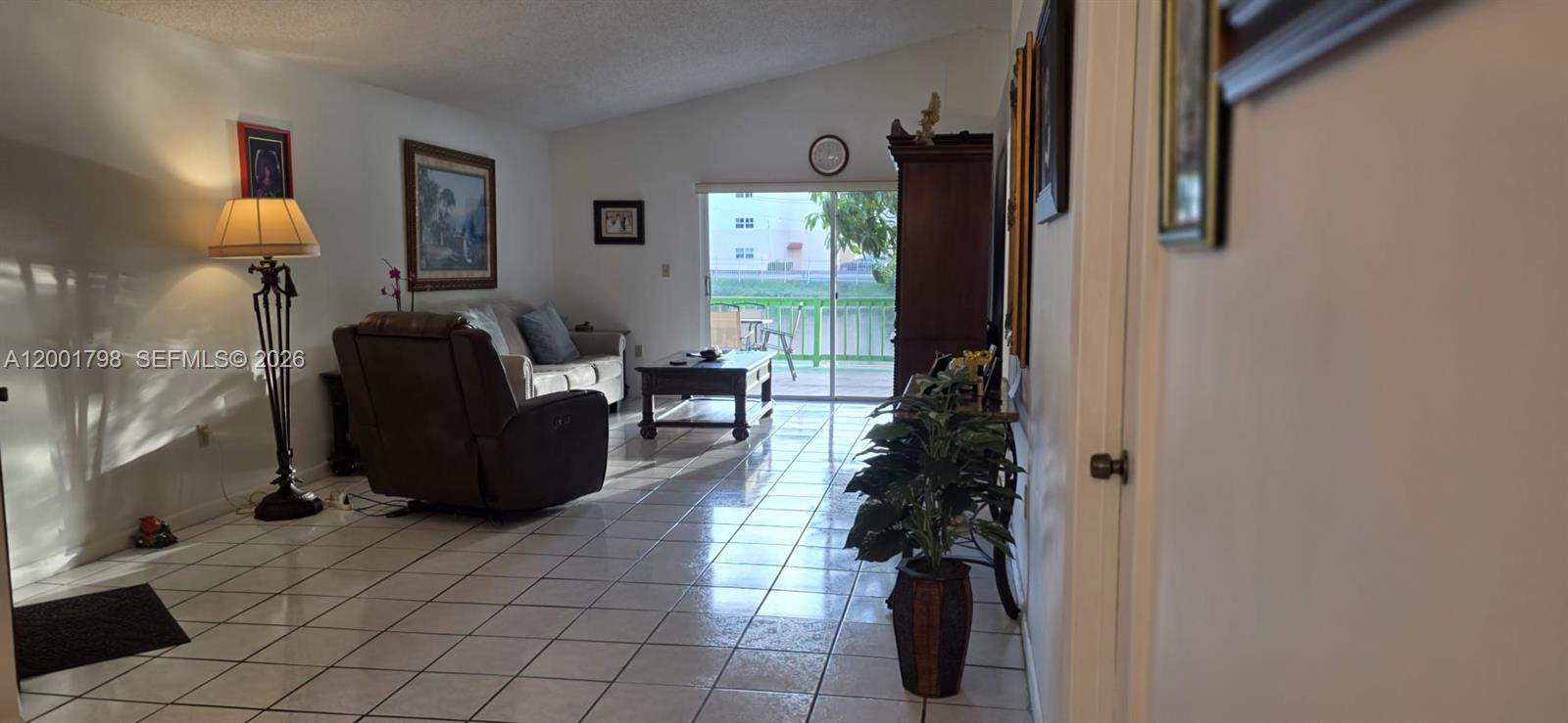 14971 Southwest 75th Terrace Miami, FL 33193 - Photo 16 of 24 a living room with furniture and a window