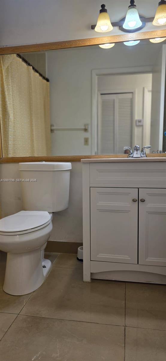 14971 Southwest 75th Terrace Miami, FL 33193 - Photo 17 of 24 a bathroom with a toilet a sink and mirror