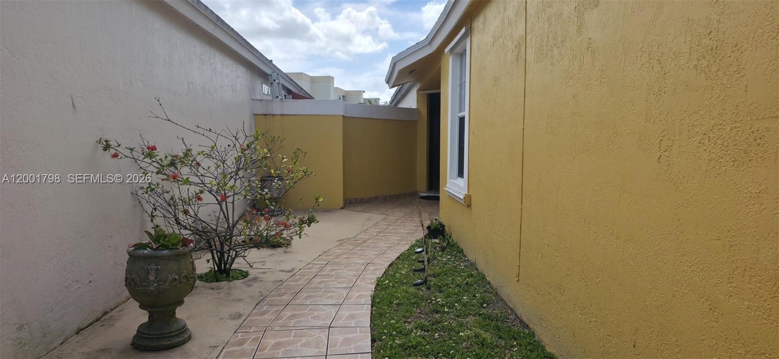 14971 Southwest 75th Terrace Miami, FL 33193 - Photo 3 of 24 a view of a pathway both side of house