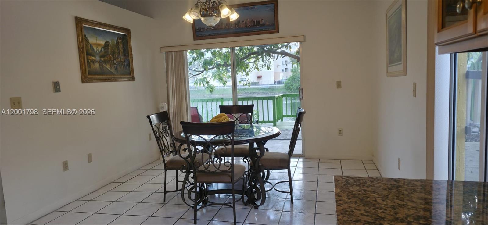 14971 Southwest 75th Terrace Miami, FL 33193 - Photo 10 of 24 a view of a dining room with furniture and a chandelier