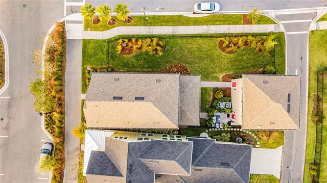 an aerial view of residential houses with yard